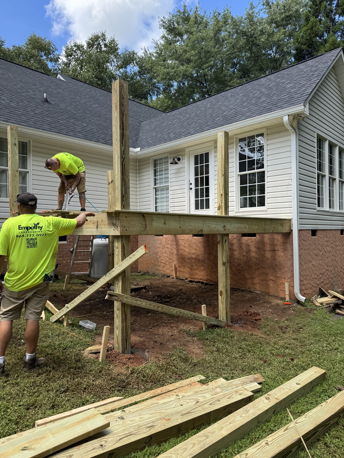 The crew constructing a timber deck at a home