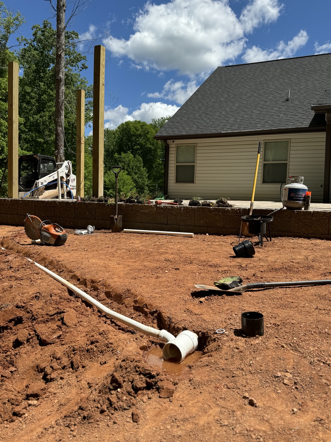Ground preparation and drainage work in a residential backyard